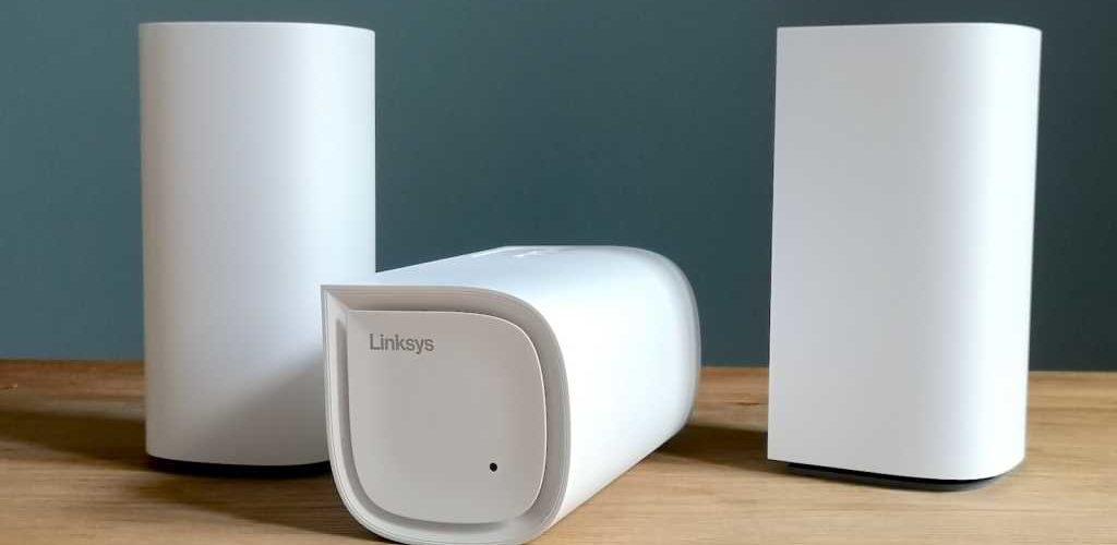 Three Linksys Velop Pro 6E units, one lying on its front, two stood up