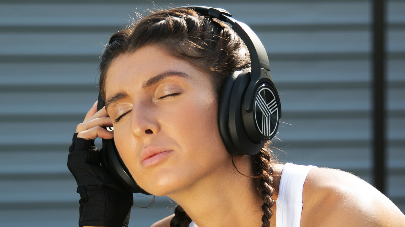 Woman working out with Treblab Z2 headphones.