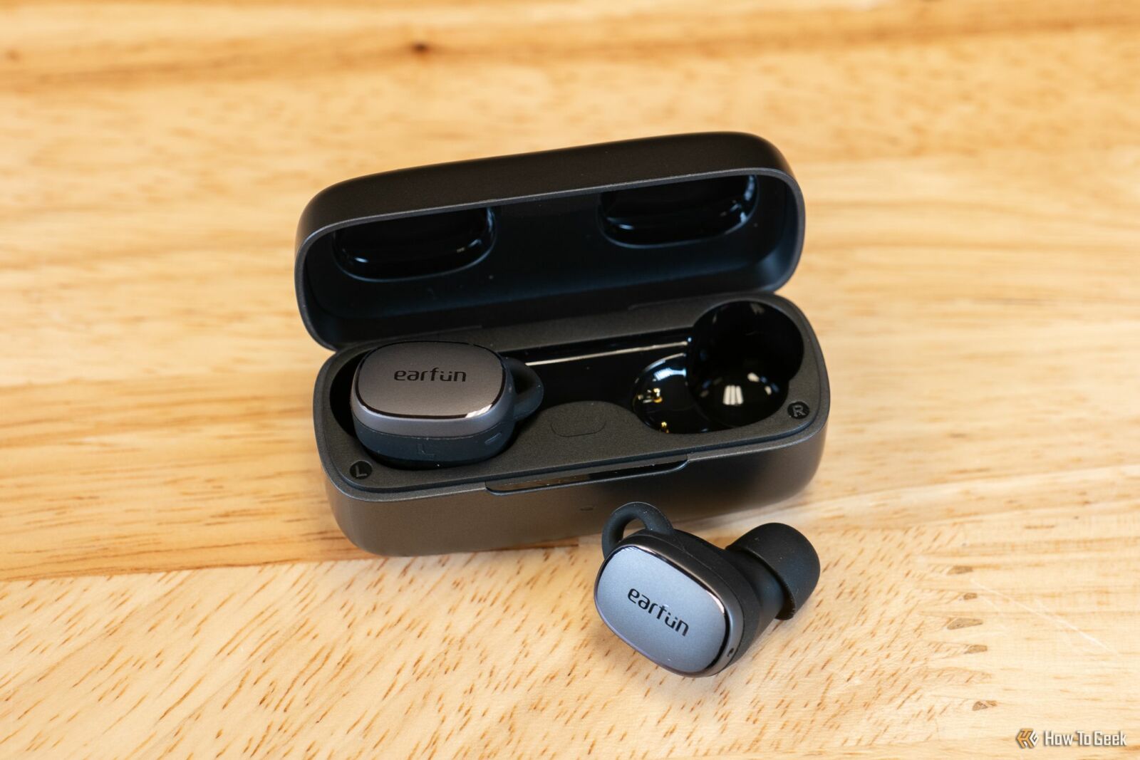 Earfun Free Pro 3 with one earbud outside of the charging case