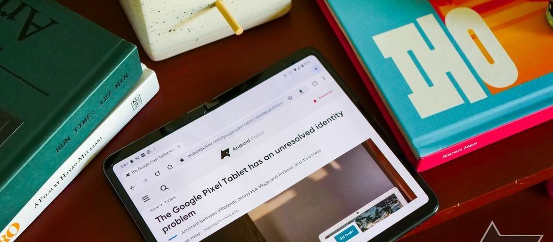 A Google Pixel Fold on a wooden table in tablet mode