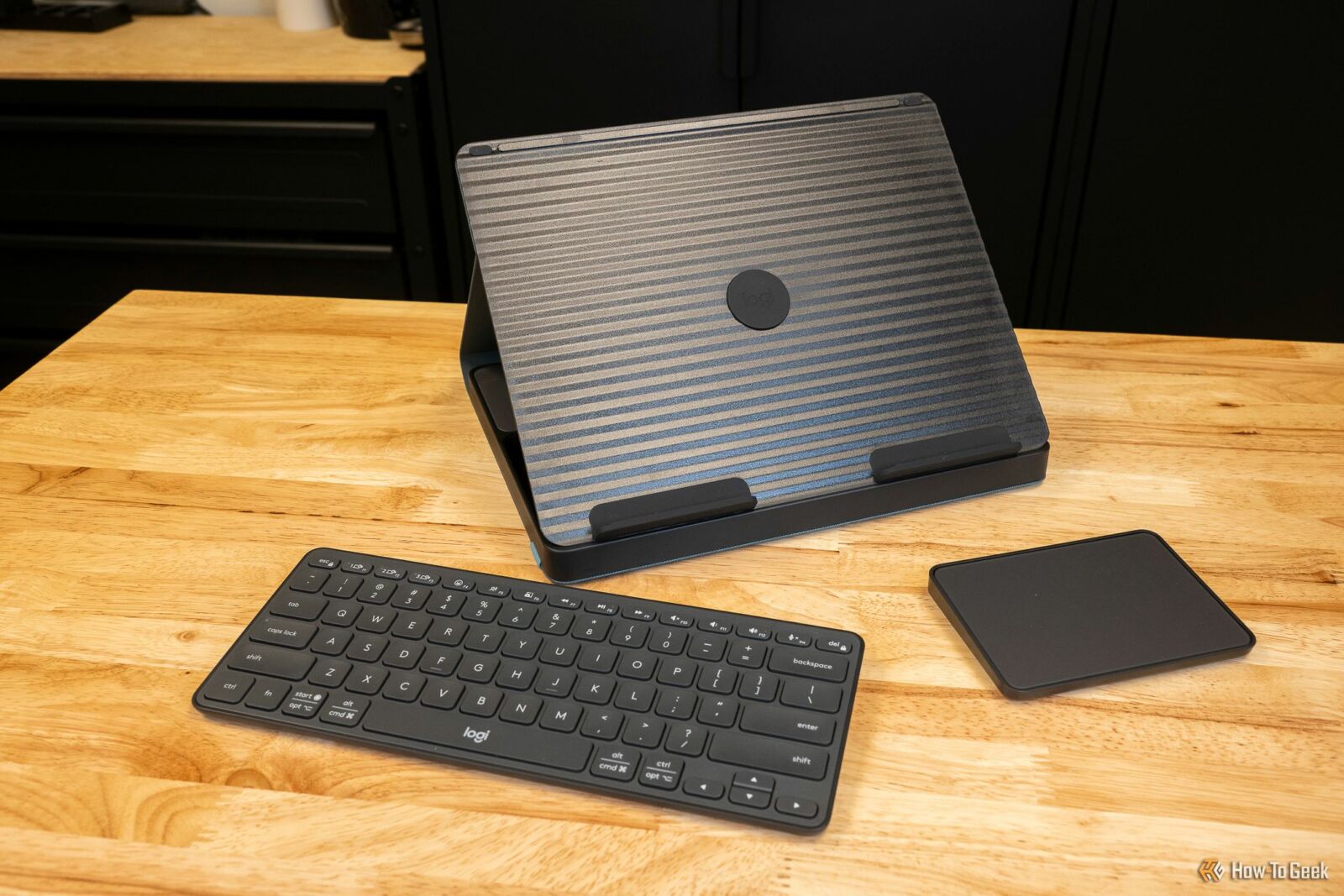 Logitech Casa Pop Up Desk with a keyboard and trackpad on a desk