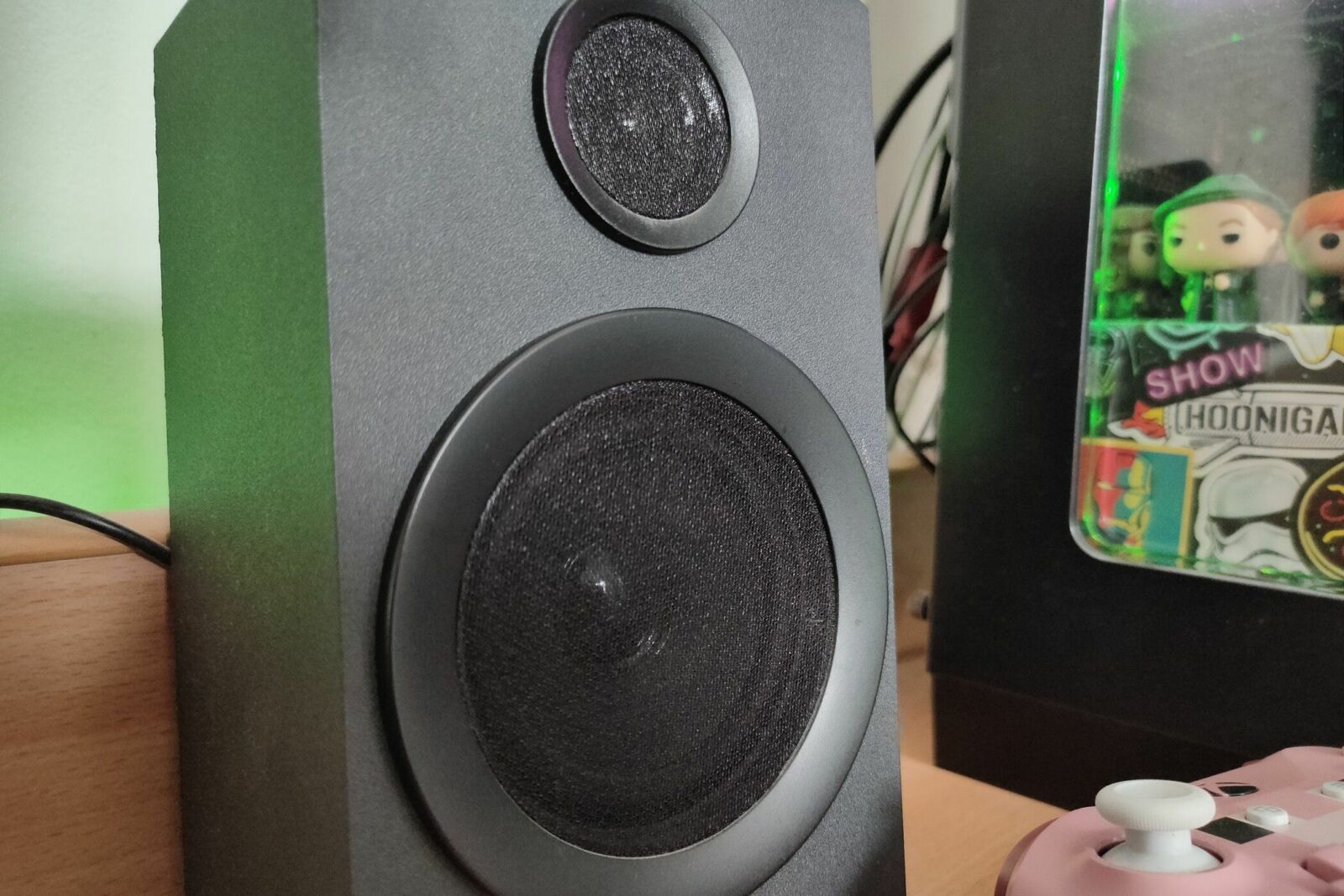 The right Logitech Z333 speaker on a desk next to a computer.