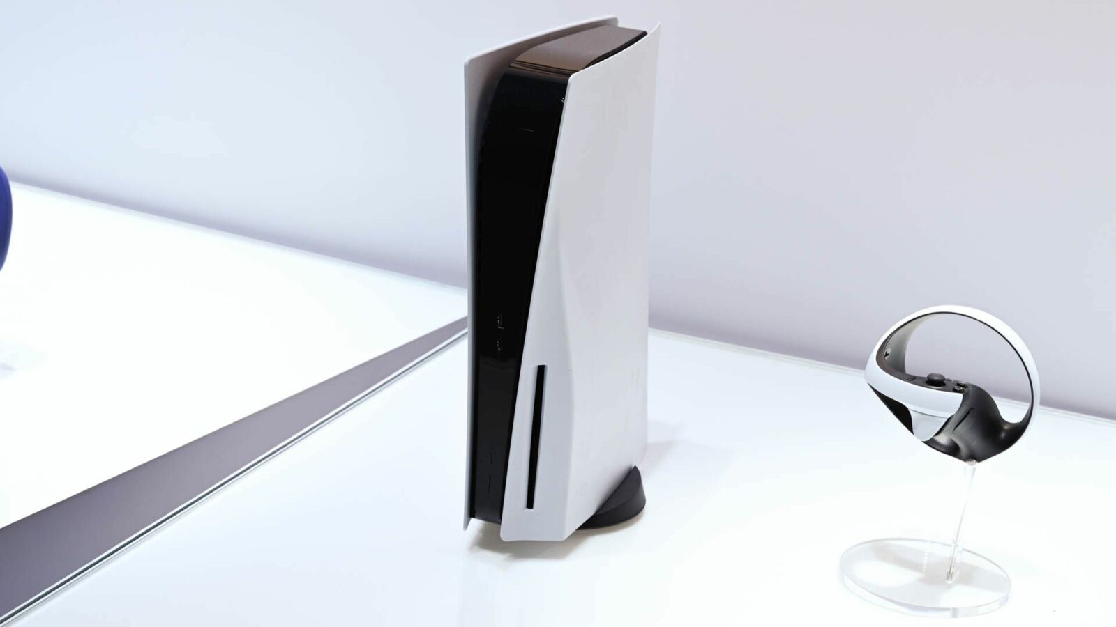 A PlayStation 5 console on a white table.