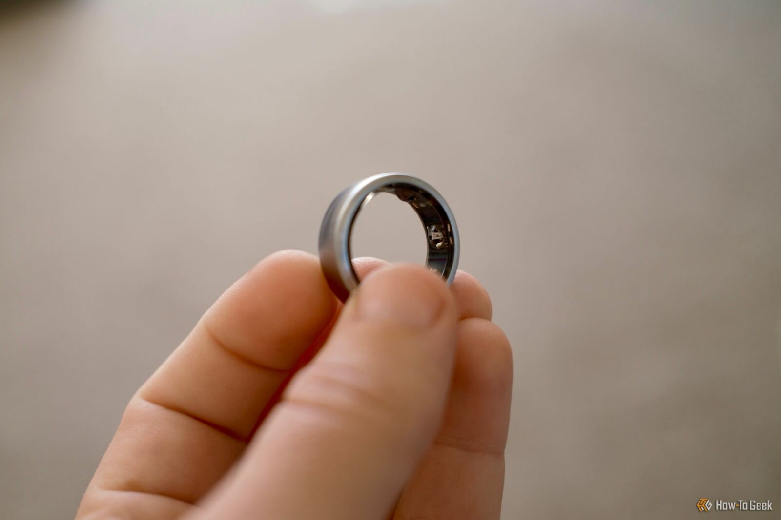 Oura Ring held in a hand